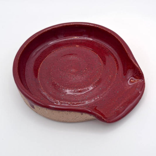Ceramic dish with a red-brown glaze on a white background